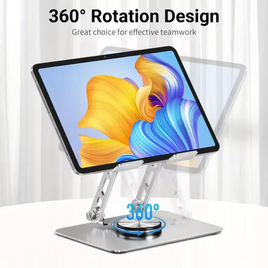 A silver tablet stand holding a tablet at an angle, with text reading '360° Rotation Design' and a blue rotation indicator graphic. The background is a clean white curtain setting.