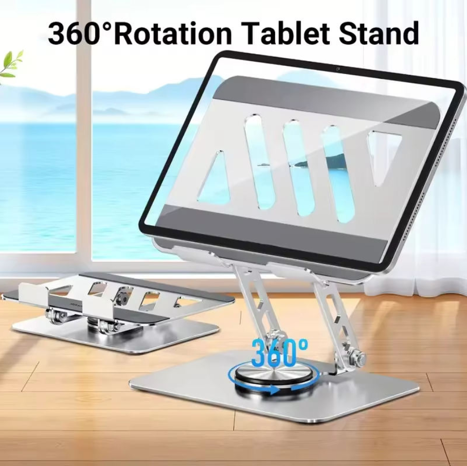 A silver metal tablet stand with a built-in screen protector, shown holding a tablet at an angle on a wooden floor in front of a window. The image includes text overlays reading '360° Rotation Tablet Stand' and '360°' with a blue circular arrow indicating rotation.