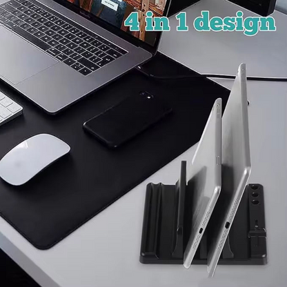 A black 4-in-1 tablet and laptop desk organizer on a white desk, shown with a tablet in two upright slots and a laptop on the desk mat. Text overlay reads '4 in 1 design'.