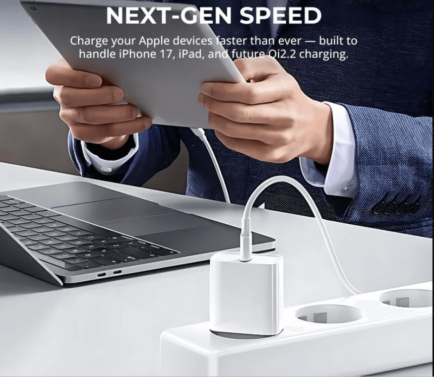 Person using a laptop with a charging adapter on a desk, emphasizing fast charging for Apple devices.