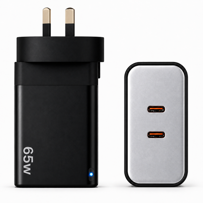 A 65W UK wall charger adapter shown from the front with its British plug on the left, and a second view of the same device from the back showing two USB-C ports on the right, against a plain white background.