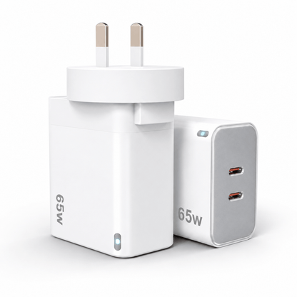 A compact white 65W UK wall charger adapter with two flat pins, shown alongside a matching white and gray 65W dual USB-C power block on a clean white background.
