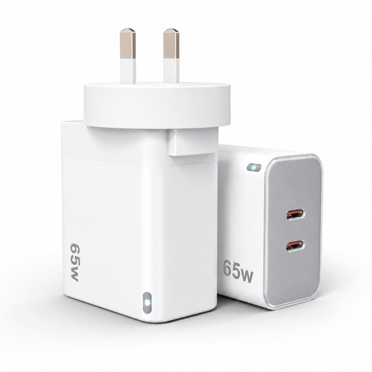 A compact white 65W UK wall charger adapter with two flat pins, shown alongside a matching white and gray 65W dual USB-C power block on a clean white background.