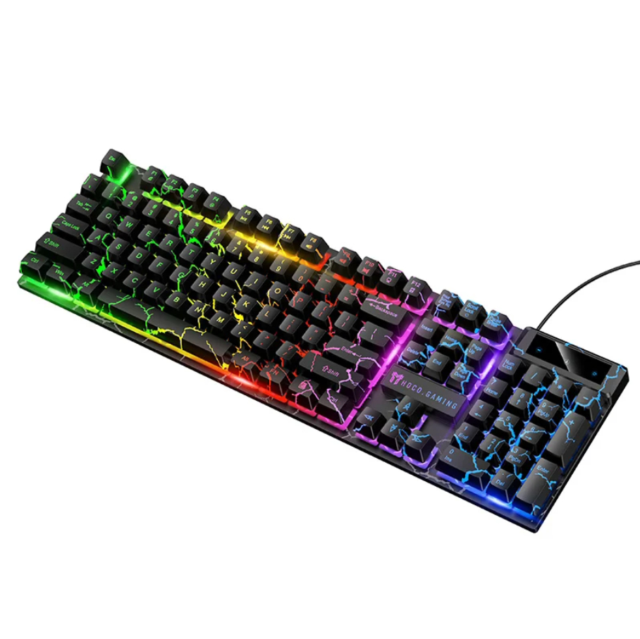 A full-size mechanical gaming keyboard with black keycaps and vibrant RGB rainbow backlighting, featuring a wrist rest and a black cable on a solid white background.