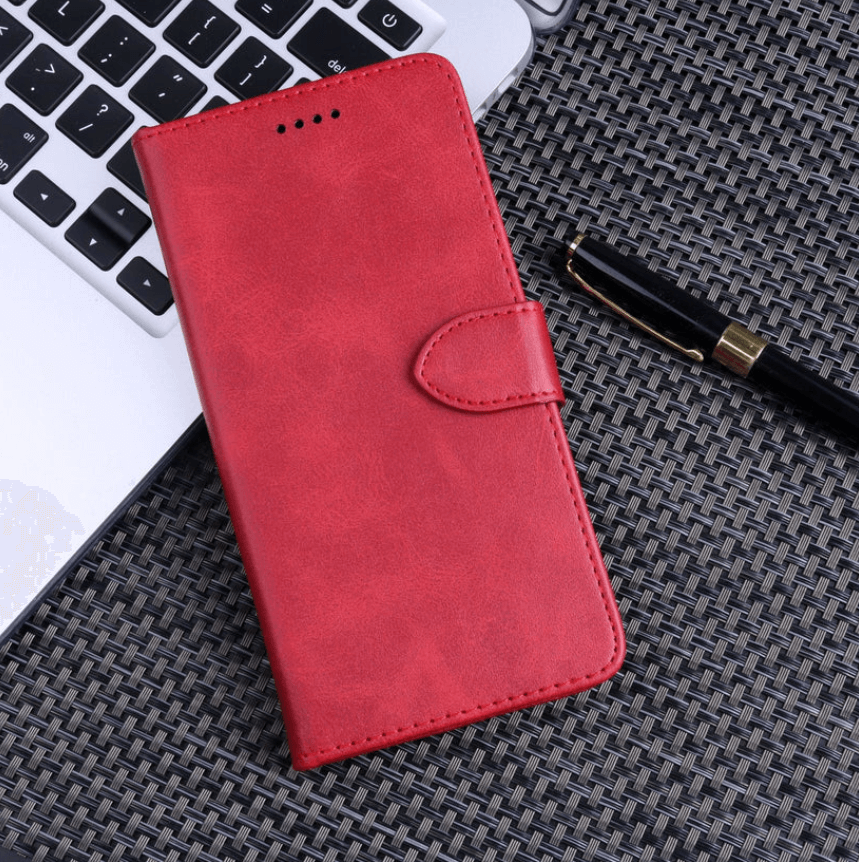Red phone case on a textured surface with a keyboard and pen in the background