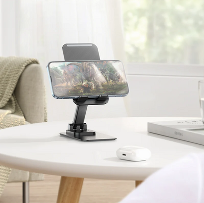 Phone holder on a table with a phone displaying a nature scene, in a home setting.