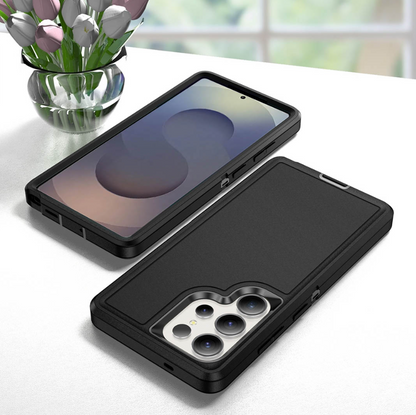 Two black rugged smartphone cases shown on a white tabletop, one holding a phone with the screen visible and one showing the back with camera cutouts. A vase of tulips sits in the background.