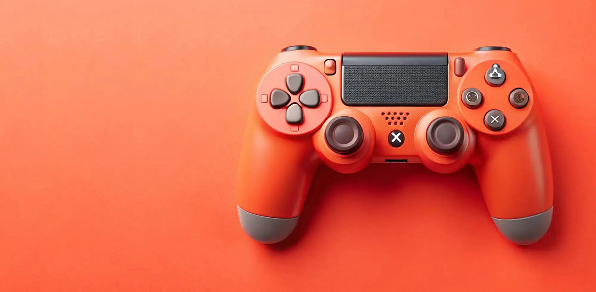 A bright orange PlayStation 5 controller with dark gray accents, shown from a top-down angle on a solid orange background.