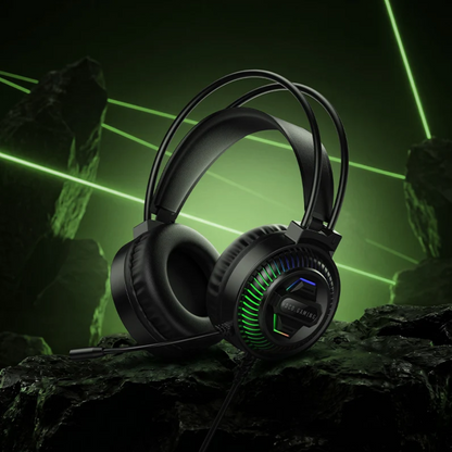 Black over-ear gaming headphones with RGB lighting accents, resting on dark rocks with a green neon laser background.